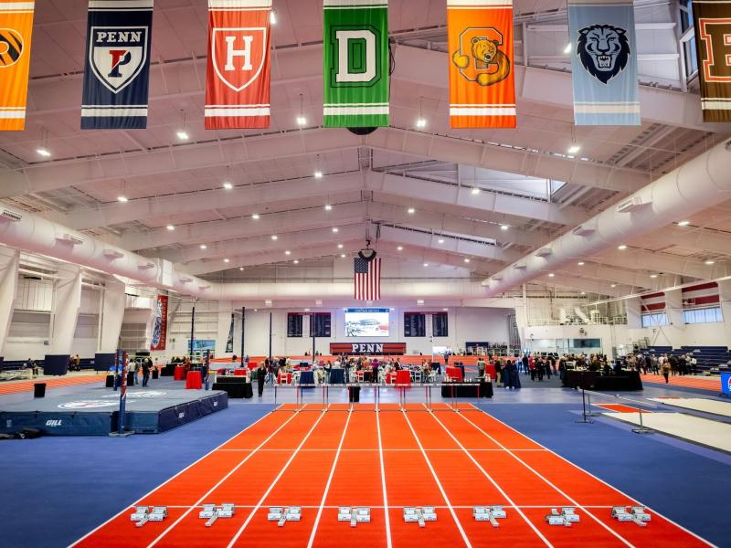 Indoor track, spectators, and hanging flags 