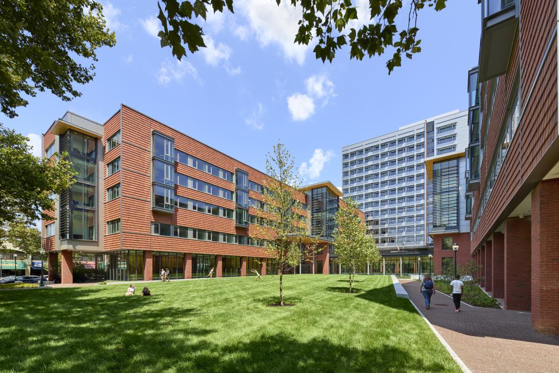 photo of gutmann college house and its green lawn on a sunny day 