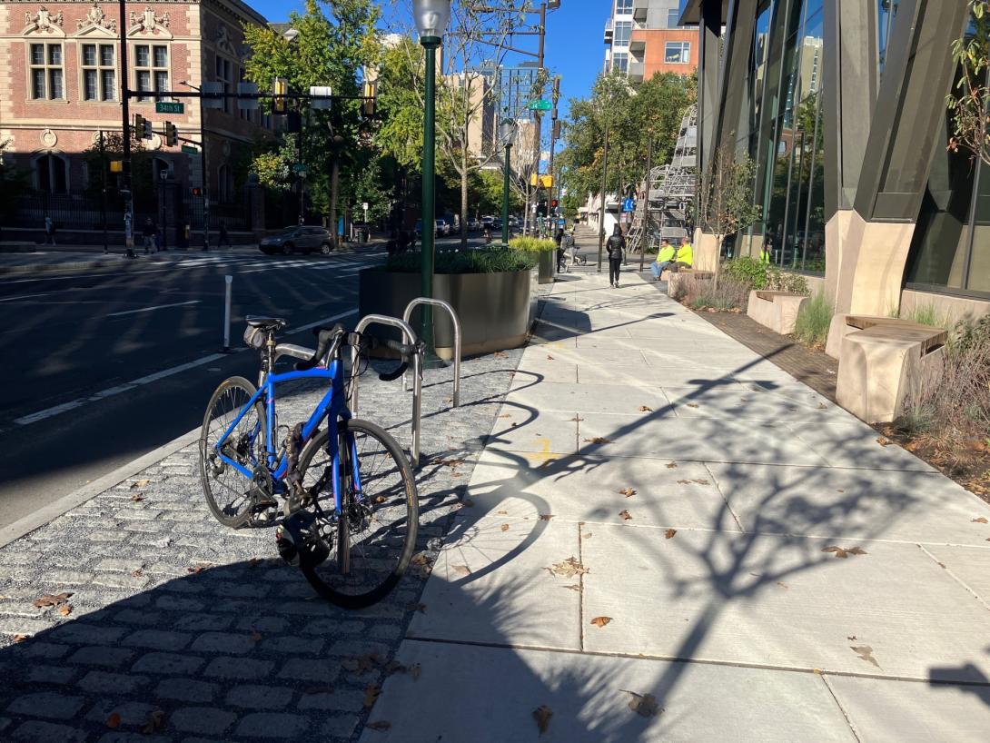 Photo of blue bike locked to a bike rack 