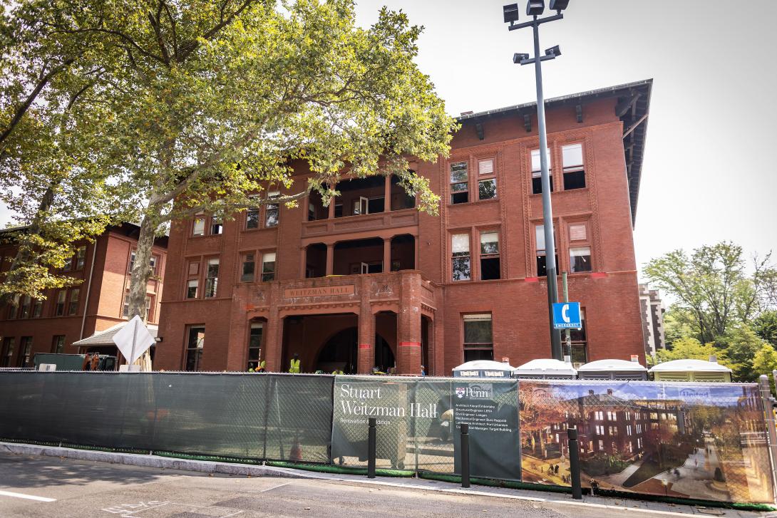 street view of red brick building under construction 