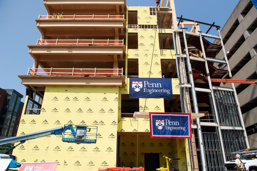 photo of building under construction with crane in front 