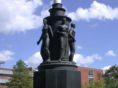 War Memorial Flagpole with figures at the base