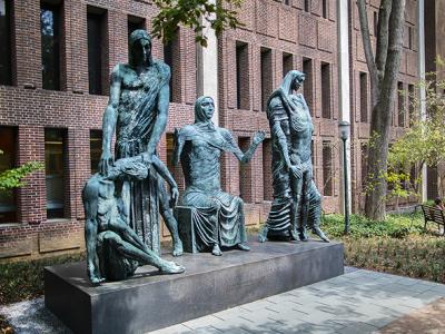 multiple people on the Social Consciousness sculpture