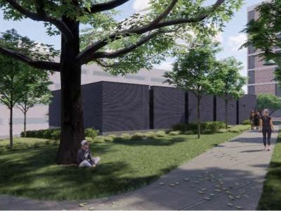 dark brick facade of substation four alongside a grassy walkway